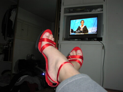 Sexy red heels while watching TV