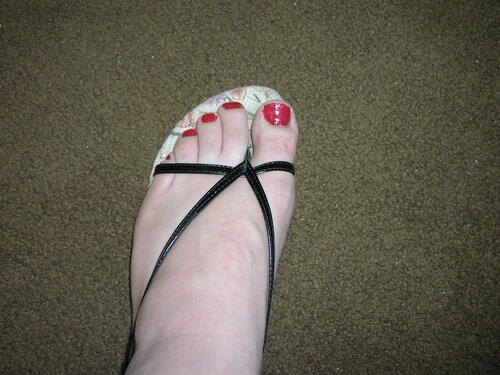 Red polished nails in sandals