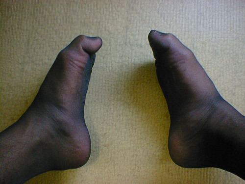 My two stockinged feet on floor